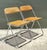 This exceptional pair of vintage Italian folding chairs embodies the understated elegance and functional ingenuity of Mid-...