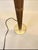 This vintage bamboo brass floor lamp from the 1960s stands at 5 feet tall and features a large shaded design. The lamp is...