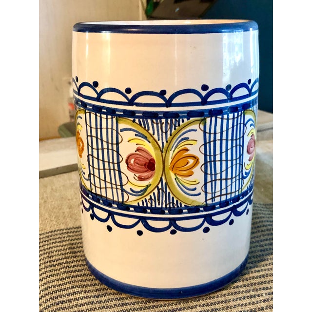 A charming vintage ceramic hand painted vessel with multiple possible uses, utensil holder, vase, wine bottle holder, etc....