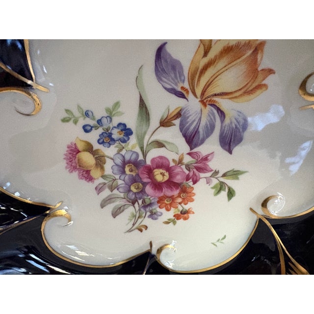 A Jimenau Graf von Henneberg German porcelain bowl. The piece has hand painted flowers in the center and a genuine cobalt...
