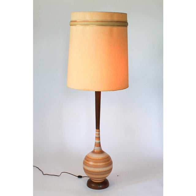 Mid-century striped ceramic table lamp with walnut neck and base. No makers mark. Minor age wear. No chips or cracks....