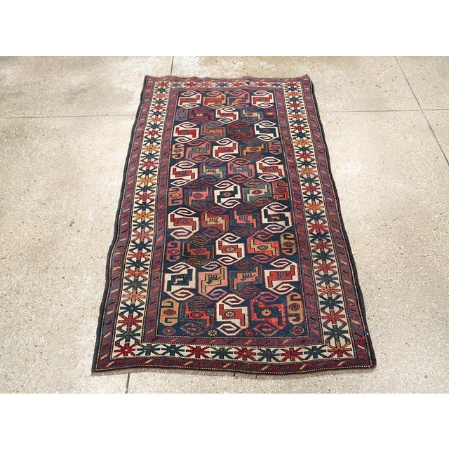 This early 20th century Caucasian Kuba rug, measuring 3' 5" x 5' 6", features a bold and dynamic composition emblematic of...