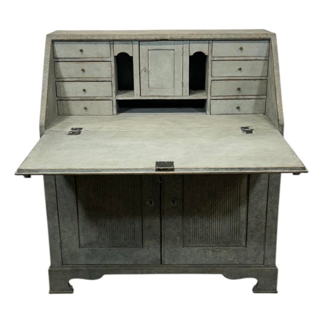 An intriguing and unusually formed antique Swedish secretary, crafted in pinewood and finished in a soft gray with subtle...