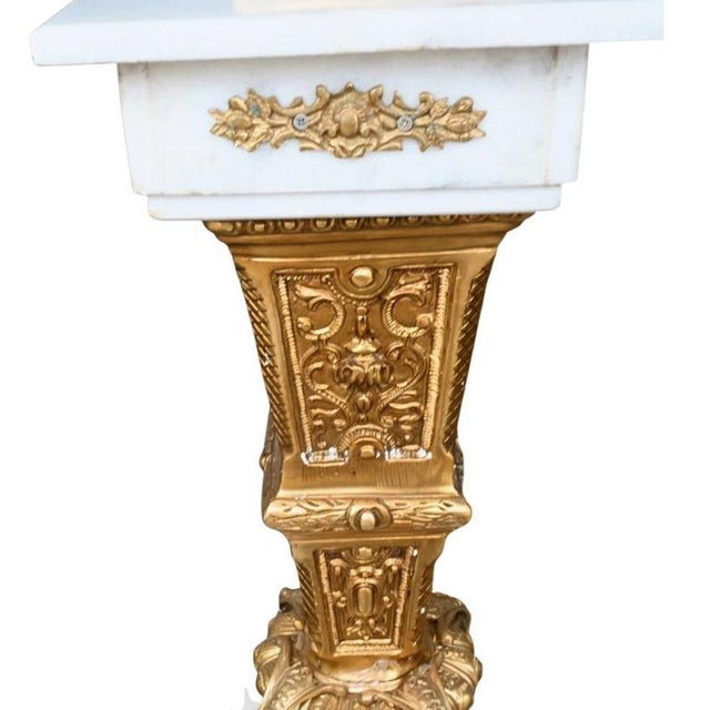 A striking and exceptionally elegant pair of tall decorative urns, crafted in white marble and richly mounted with finely...