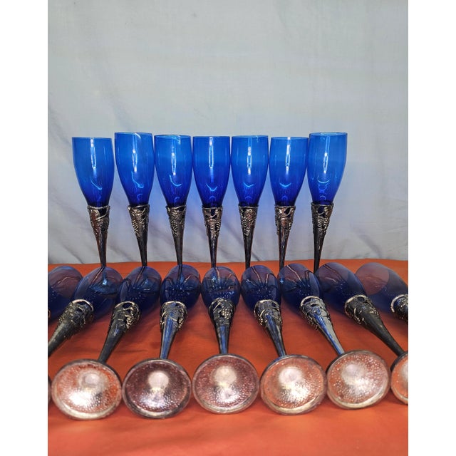 Cobalt / Blue Champagne Glasses with a silver overlay of grapevine motif. Flutes are hand-blown so they are not identical....