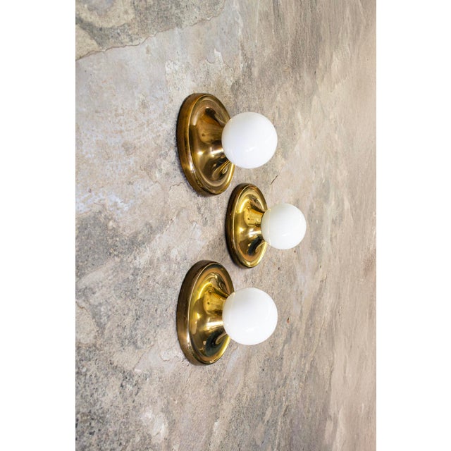 Wall lamp with brass structure and glass lampshade. Model Light Ball Designer Achille & Pier Giacomo Castiglioni...