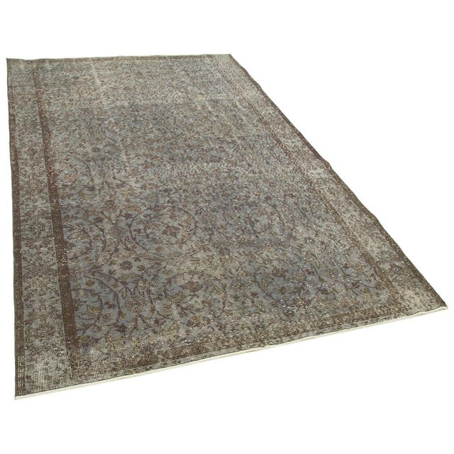 Elevate your home with the timeless charm of a vintage overdyed rug. Handwoven by skilled artisans, each rug tells a story...