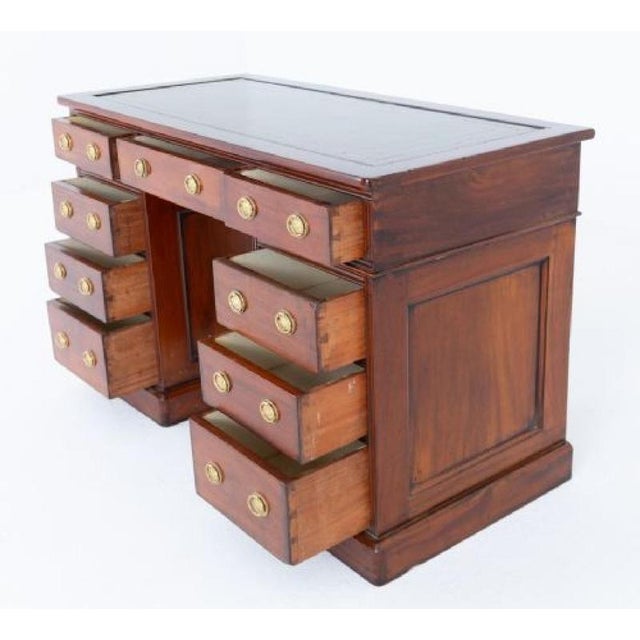 A handsome Victorian mahogany twin pedestal desk, standing on a plinth base and featuring a traditional arrangement of...