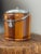A charming vintage English biscuit barrel featuring a beautifully crafted two-toned wood exterior that creates a subtle...