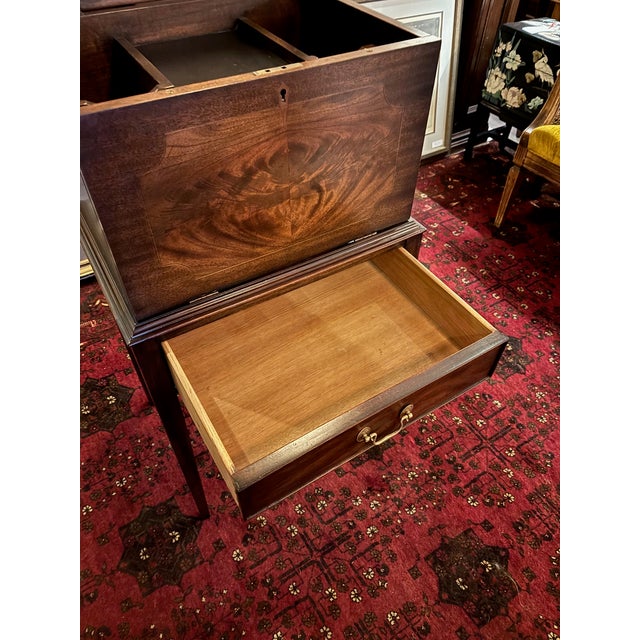 Measures 40” high x 21.5” wide x 16” deep A beautifully crafted solid mahogany liquor cabinet by Henkel Harris, executed...