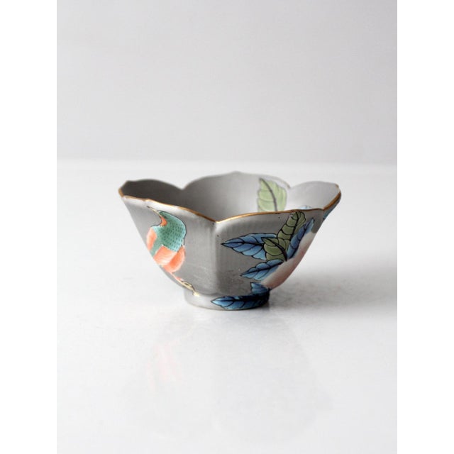 Vintage Japanese porcelain bowl with a softly scalloped rim and a delicately hand-painted bird and floral motif. The muted...