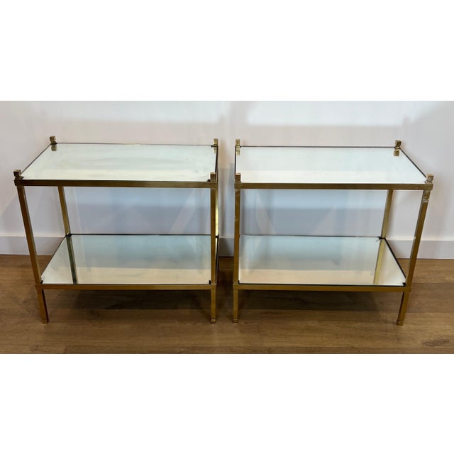 This pair of side tables is made of gilded brass with mirrored tops. This is a French piece. Circa 1970