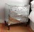 Antique-mirrored three-drawer chest with Lucite handles, glass top and wood Cabriole legs, c. 1940s. Purchased from...