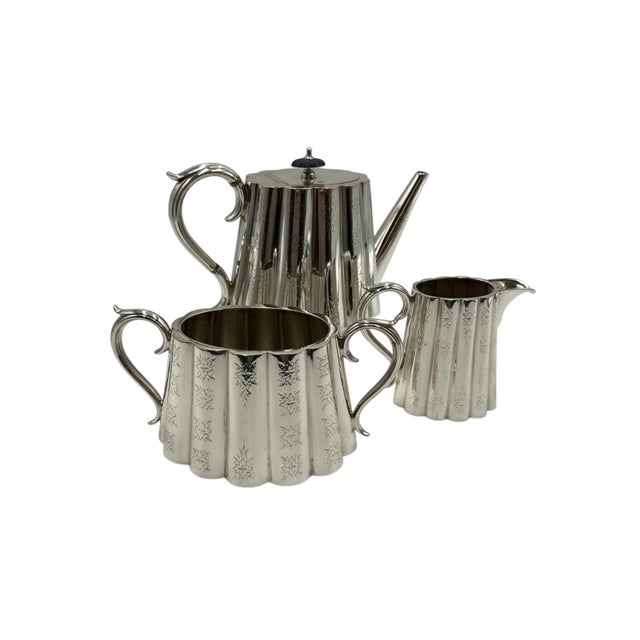 This three-piece Grosvenor silver service represents a classic tea set, consisting of a teapot, sugar bowl, and creamer....