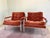 A pair of nickel plated lounge chairs in rust colored velour. A classic design from the 1970’s by Cy Mann.