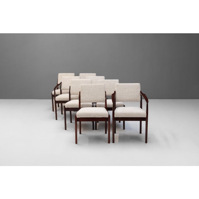 Set of 8 mid-century dining chairs. Six side chairs with two carver chairs. The frames have been polished and are brought...