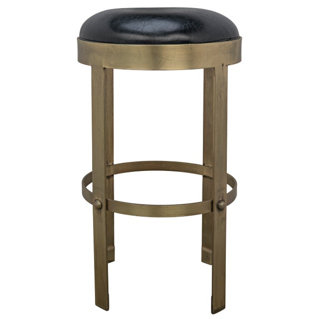 Thick circular bands of metal form this stool's footrest and support its black leather seat. Royally finished in gold with...