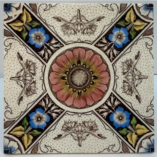 Antique English Decorative Tile, circa 1880 Glazed ceramic tile with polychrome transfer decoration, featuring an ornate...