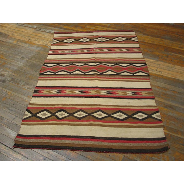 The robust red and creamy ivory contrast in this wide ruins blanket style scatter. The pattern is based on horizontal zig-...