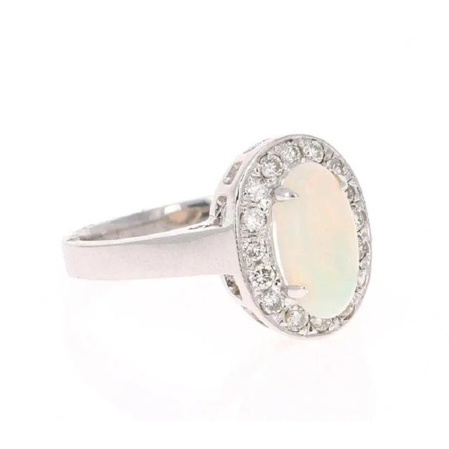 This ring has a cute and simple 1.16 Carat Opal and has 16 Round Cut Diamonds that weigh 0.32 Carats. The total carat...