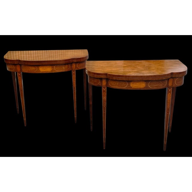 Featured is a pair of elegant Vintage Baker Furniture Federal Style Inlaid Mahogany Card Tables, beautifully crafted with...