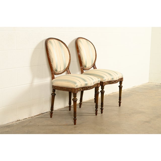 A gorgeous pair of French Regency Louis XVI style side chairs or dining chairs In the manner of Karges Furniture USA,...