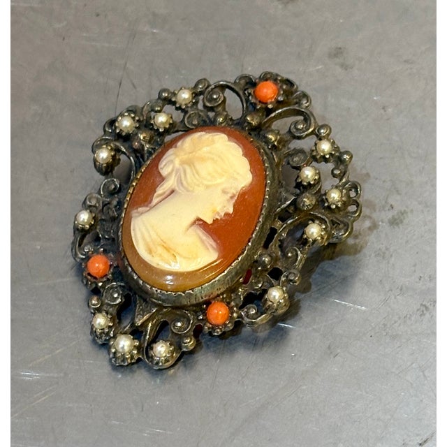 Early 20th-century silver tone, faux pearl and coral cameo brooch or pendant. Excellent condition.