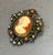 Early 20th-century silver tone, faux pearl and coral cameo brooch or pendant. Excellent condition.
