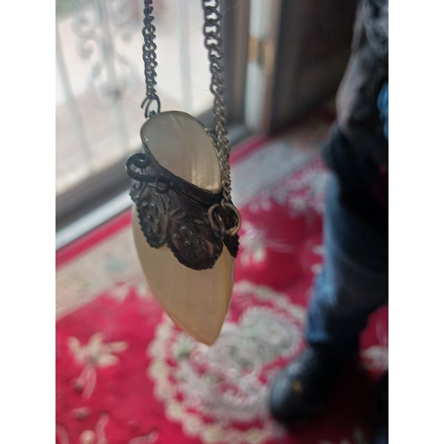 Antique Sniffer bottlee with chain for hanging/carrying small items. Made of polished shell and brass.