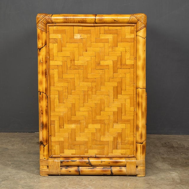 A mid 20th Century French chest of four drawers in bamboo and woven raffia detail with original brass handles. In good...