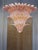 Chandelier made with pink “PALMETTE” elements of Murano glass with a gold 24k metal brass finishing that give a thouch of...