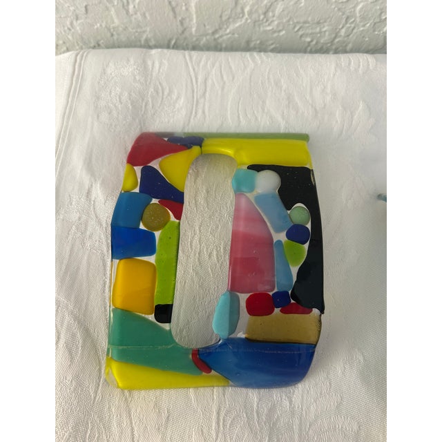 Colorful set of four, hand-made, concave, abstract fused glass objects that can be used to create a striking wall display....