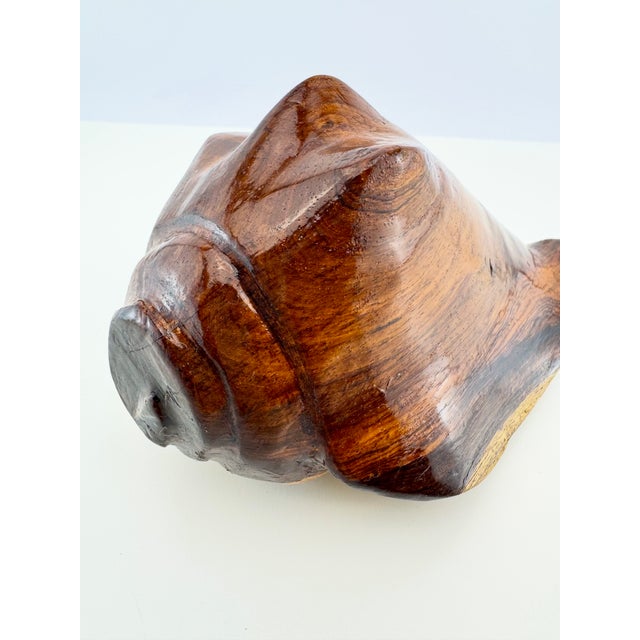 A vintage hand-carved wood sculpture modeled as a conch shell, with sweeping curves, raised ridges, and a deeply carved...