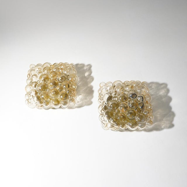 A pair of ceiling lights designed by helena tynell for limburg in the 1970s, a project that explores the expressive...