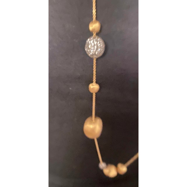 Vintage Marco Bicego 18K gold and diamond necklace - 36 inches long with a claw clasp. The necklace has 4 mounted multiple...