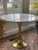 This is a stylish Stockholm dining table sometimes called a tulip table. The top is white marble and the base is hammered...
