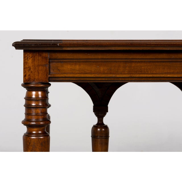 A late 19th-century French Henri II Revival library table crafted in walnut, distinguished by its architectural base,...