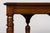 A late 19th-century French Henri II Revival library table crafted in walnut, distinguished by its architectural base,...