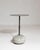 Round stone-base side table in Deep Charcoal Grey. The deep charcoal grey surface highlights rounded natural stone base,...