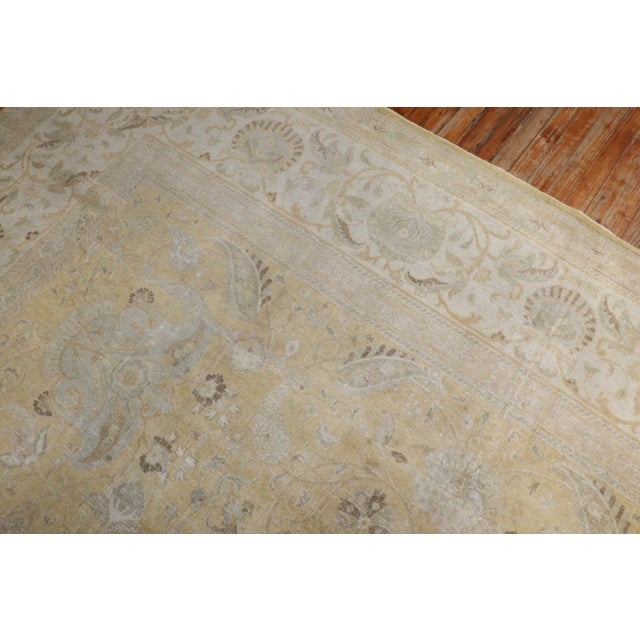 An early 20th-century antique Persian Tabriz room-size square rug in gold and ivory tones Measure: 10'8'' x 12'5'' Tabriz...