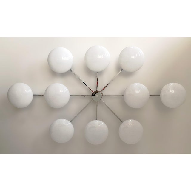 Italian midcentury flush mount with ten glossy white Murano glass shades mounted on solid brass frame in polished chrome...
