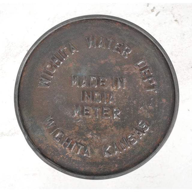 Reclaimed cast iron water meter cover stool with a steel frame. This would also make a great side table or plant stand....