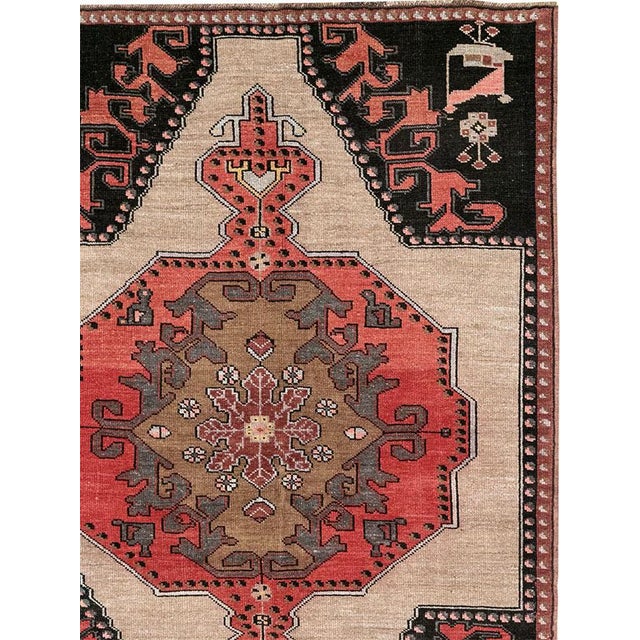 This Mid-20th century Turkish Anatolian room-size carpet presents a bold compartmentalized composition arranged in four...