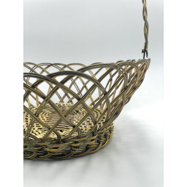 This hand-crafted solid brass woven basket was made by WR. Rogers & Sons. This oval basket would make the most festive...