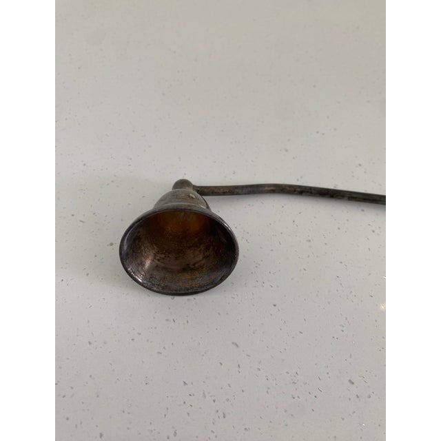A beautiful traditional silver-plated candle snuffer.