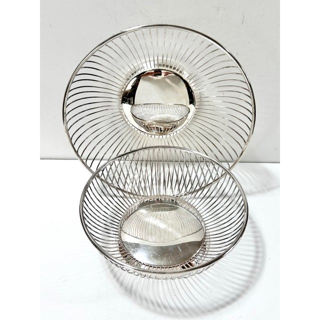 This elegant set of vintage silverplate wire baskets features a classic openwork design with finely spaced vertical ribs...