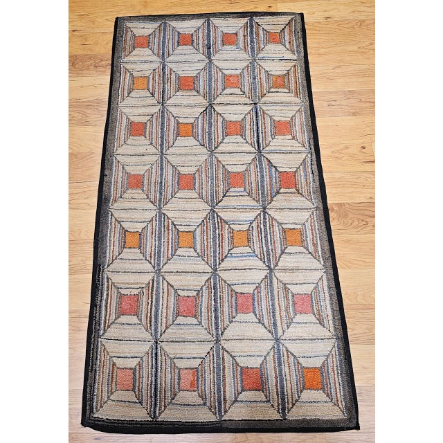 Celebrate the charm of American folk art with this exceptional vintage hand-hooked rug, crafted in the late 1800s in the...
