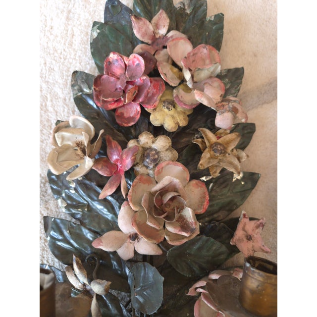 Circa 1940s Italian tole sconces. This is a pair of sconces with deep green leaves and beautifully colored flowers. The...