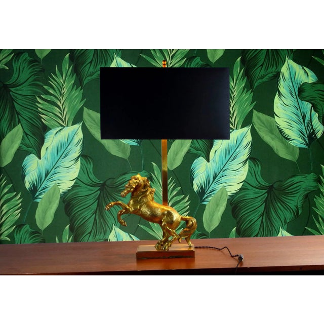 This large Hollywood Regency table lamp features a gold-plated horse standing on its hind legs, and a brass base. It was...