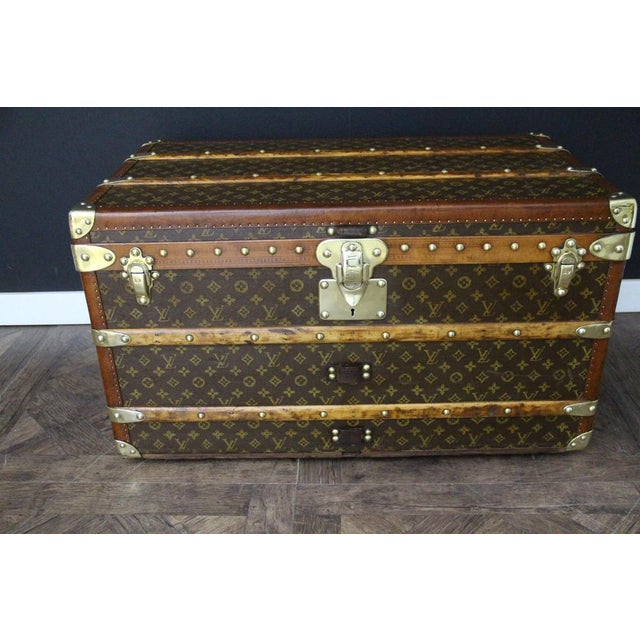 This stunning vintage Louis Vuitton trunk features a magnificent hand-stenciled Monogram canvas, honey-colored diamond-...